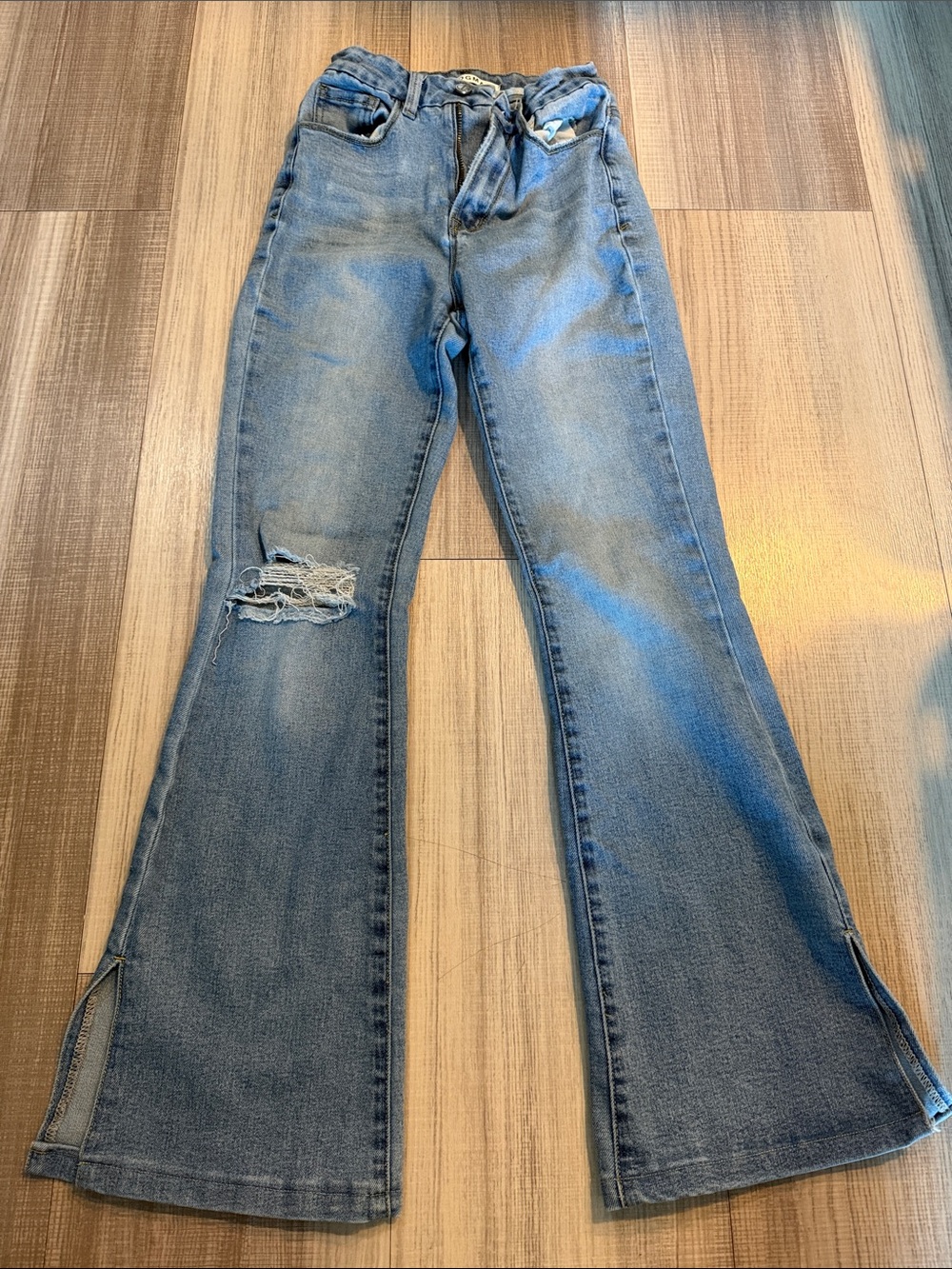 Light Blue High-Rise Flare Jeans with Distressed Knee and Split Hem